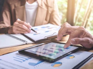 Private funds are a simplified way to diversify a financial portfolio. Picture of two people reviewing spreadsheets